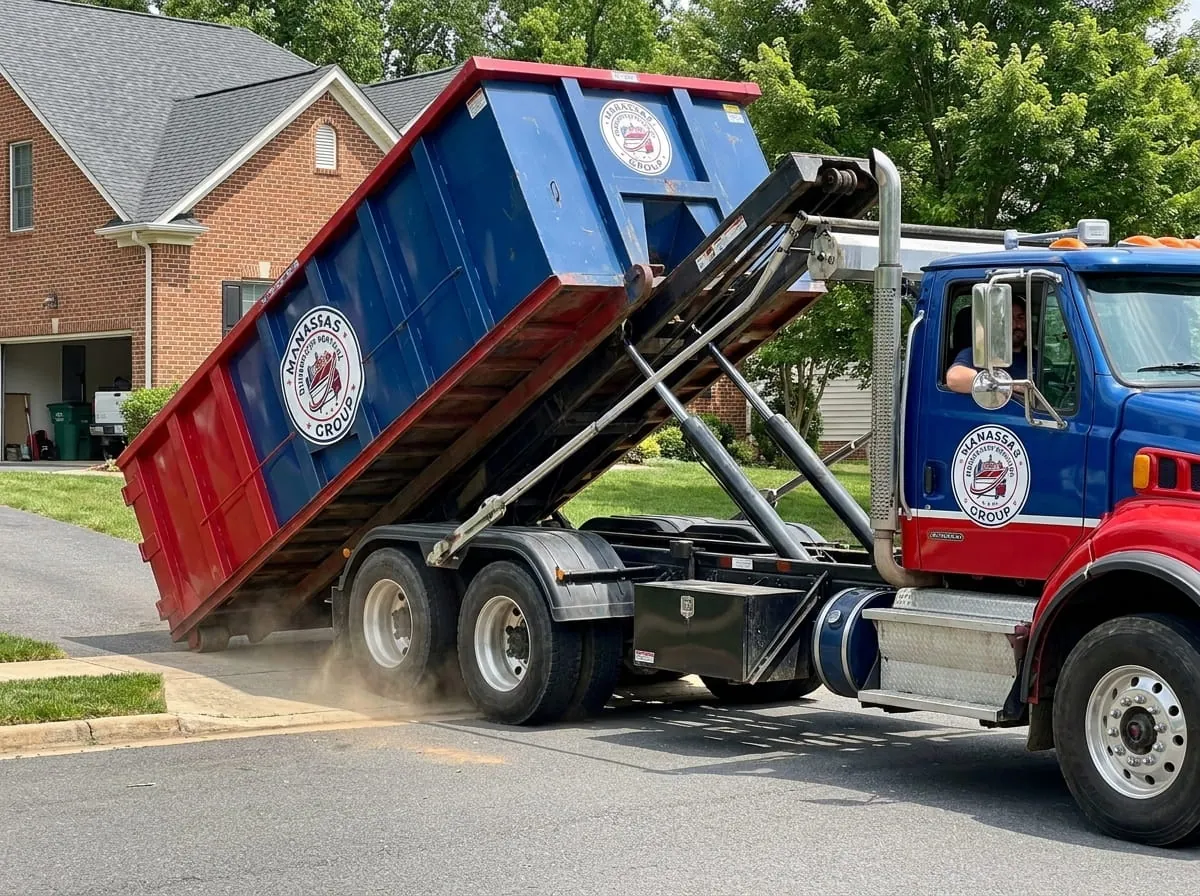 Junk removal in Manassas, VA Workers loading furniture and junk into a dumpster in Manassas, VA